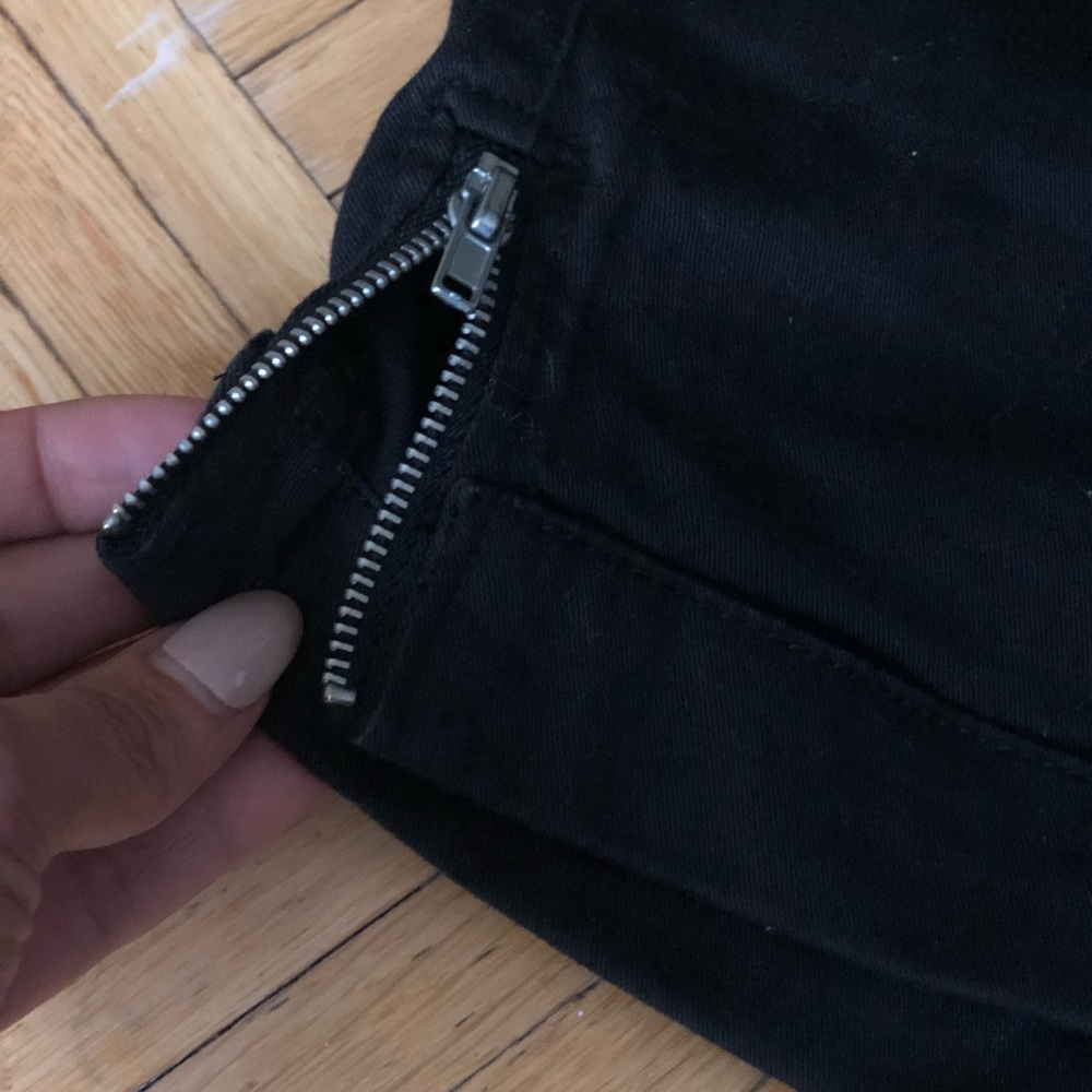 Black twill shorts with side zipper detail.